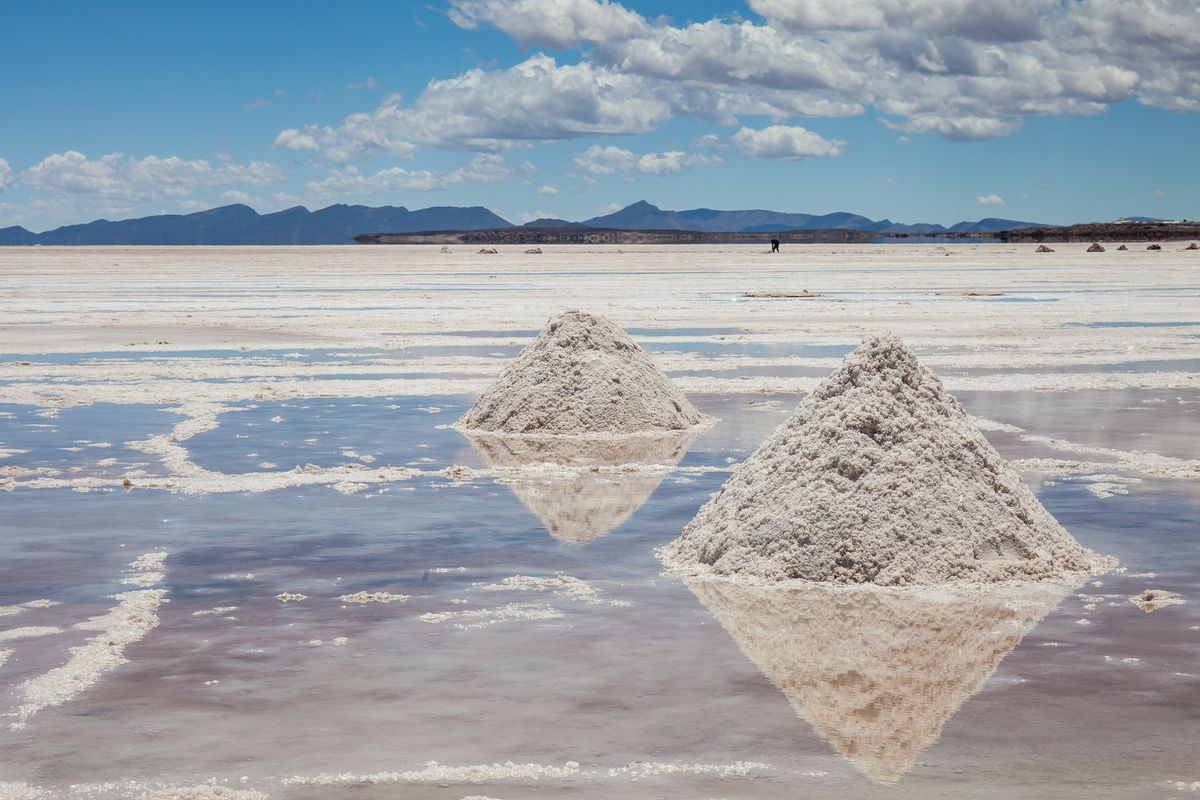 Heaps of salt in the Salares de Uyuni, Bolivia. Blue sky background with clouds